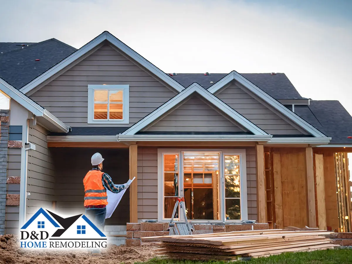 male professional contractor performing expert residential home remodeling service by construction a professionally designed home addition to exterior