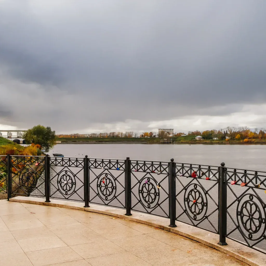 River view with a decorative black railing under a cloudy sky.