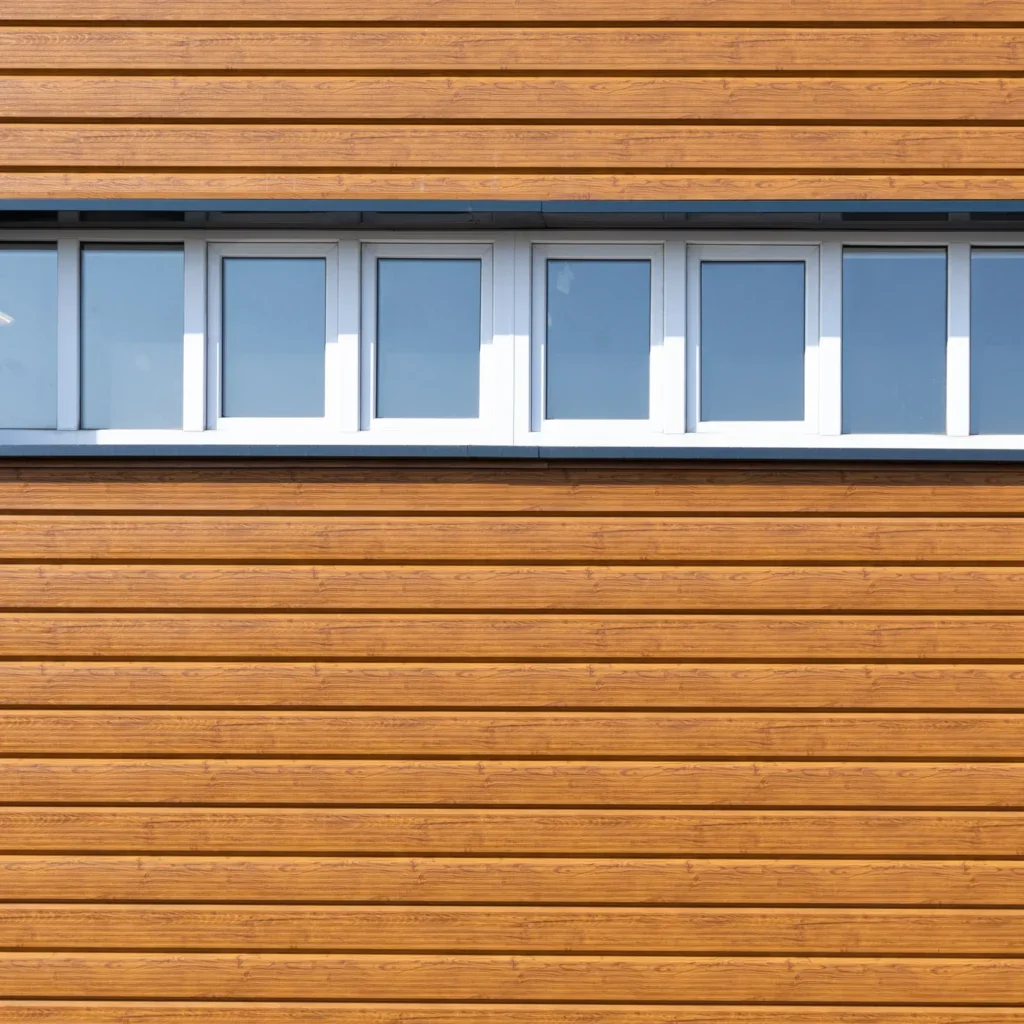 Long rectangular window with six panes on a brown wooden wall.
