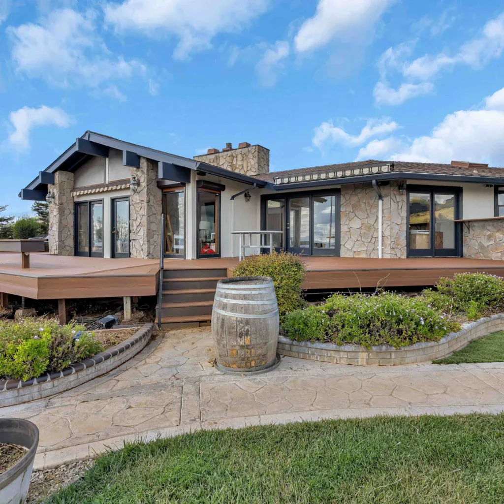 Modern home exterior with large deck and stone accents in San Jose.